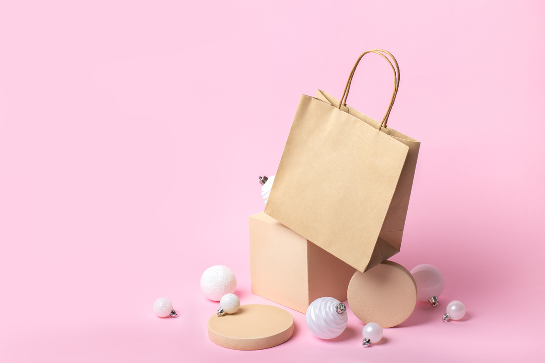 Kraft paper bag mockup with beige geometric podiums and Christmas balls